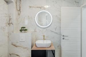 a bathroom with a white sink and a mirror at Apartman Sea in Podstrana +19 photos