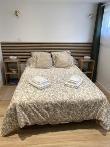 a bedroom with a bed with two towels on it at Dune et Terrasse in Merville-Franceville-Plage