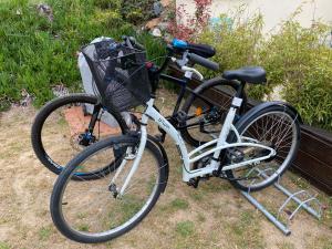 a bike with a basket is parked in the grass at Dune et Terrasse in Merville-Franceville-Plage