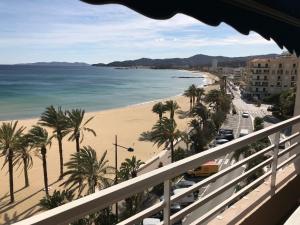 une vue sur une plage avec des palmiers et l'océan dans l'établissement Appart T2 avec garage, balcon et ménage inclus au Lavandou - FR-1-308-57, à Bormes-les-Mimosas