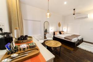 a living room with a bed and a table at FeelHome in Cochin