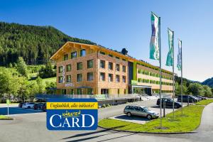 a building with a car parked in front of it at Explorer Hotel Bad Kleinkirchheim in Bad Kleinkirchheim