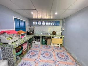 a kitchen with a tile floor in a room at Earnhomestay sichon in Ban Plai Thon