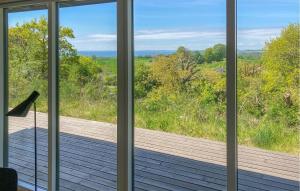 a view from a window of a wooden deck at Nice Home In Knebel With House Sea View in Knebel