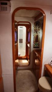 a small room with a mirror on a boat at ALL ONE Catamaran in Ponta Delgada