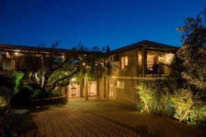 a large house with a driveway at night at The Cape Bali in Cape Town