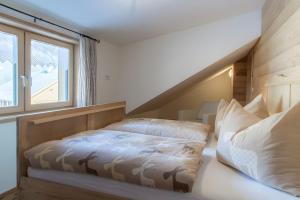 a bedroom with a bed and a window at Appartement Moosmann in Mellau