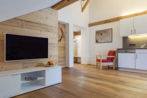 a living room with a flat screen tv on a wall at Appartement Moosmann in Mellau +30 photos