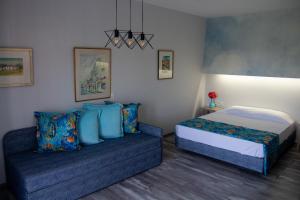 a bedroom with a bed and a couch at Aliston Hotel Thassos in Skala Potamias