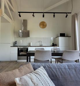 a kitchen and dining room with a table and chairs at Vakantiewoning aan het water, vissen, wandelen en genieten in de natuur in Geel