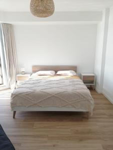 a bedroom with a bed in a white room at Buarcos&Sea Accommodation - Cristal Mar - Your Panoramic Ocean View Retreat in Figueira da Foz
