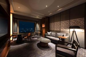 a living room with a couch and a table at Cerulean Tower Tokyu Hotel, A Pan Pacific Partner Hotel in Tokyo