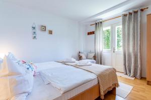 Postel nebo postele na pokoji v ubytování Apartments Katarina