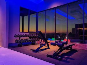 a gym with exercise equipment in a building with a view at Alor Setar Sunny Bear Suites in Alor Setar