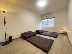 Postel nebo postele na pokoji v ubytování 長橋屋