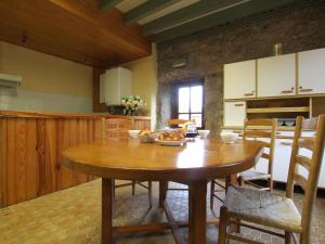 a kitchen with a wooden table in a room at Gîte de charme 10 pers. à Saint-Vert - Nature préservée, 4 chambres, jardin clos - FR-1-582-307 in Saint-Vert