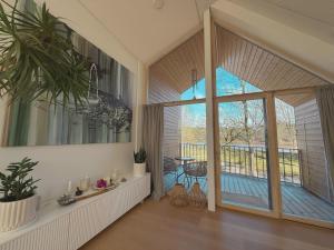 a living room with a sliding glass door and a patio at Oak Zen Home in Birštonas
