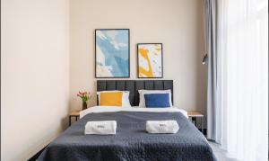 Posteľ alebo postele v izbe v ubytovaní IND.U Apartamenty