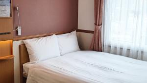 Voodi või voodid majutusasutuse Toyoko Inn Atami Ekimae toas