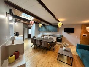 a living room and kitchen with a table and a couch at grange la pignata orelle in Orelle