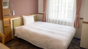 Voodi või voodid majutusasutuse Toyoko Inn Atami Ekimae toas