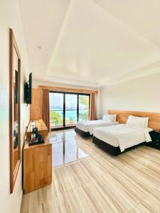 Voodi või voodid majutusasutuse AIMI Beach Hotel toas