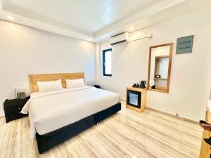Voodi või voodid majutusasutuse AIMI Beach Hotel toas