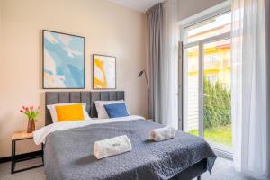 Posteľ alebo postele v izbe v ubytovaní IND.U Apartamenty