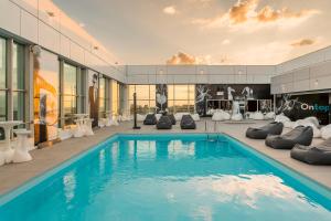 a swimming pool in the middle of a building at HF Ipanema Park in Porto