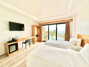 Voodi või voodid majutusasutuse AIMI Beach Hotel toas