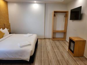 Voodi või voodid majutusasutuse AIMI Beach Hotel toas