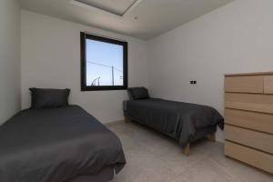 a bedroom with two beds and a window at The Stables in Arona +43 photos