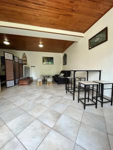 a large living room with tables and a couch at Grand studio en rez-de-jardin in Flins-sur-Seine