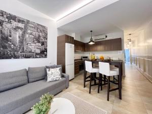 a living room and kitchen with a couch and a table at Torre de Gracia Barcelona in Barcelona