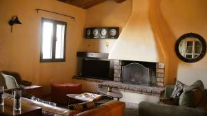 a living room with a fireplace and a tv at Domaine de Gialla Bergerie Carta, 6 pers, montagne, vue mer in Porto-Vecchio