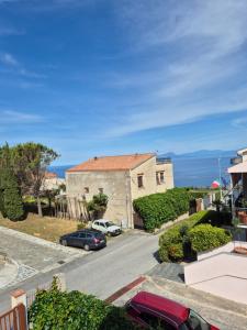 a house with cars parked in a parking lot at Al Belvedere di San Nicola Arcella in San Nicola Arcella +9 photos