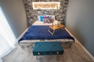 a bedroom with a large bed with a table on it at Y Palmela - Boutique Apartments in Palmela