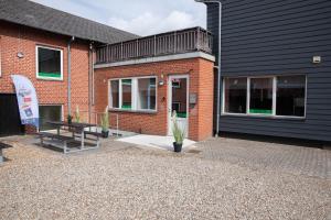 a brick building with a table in front of it at STAY and SLEEP Grindsted - Billund in Grindsted