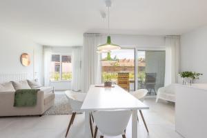 a white living room with a white table and chairs at LECOMTE - The Shoreline Green 153 in Ostend +13 photos
