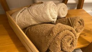 a wooden box filled with towels on a table at Le Patio du bien-être in Béziers