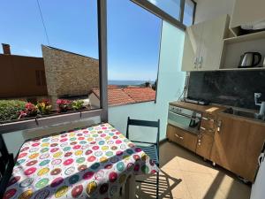 a kitchen with a bed and a large window at Hotel Europa Kruje in Krujë