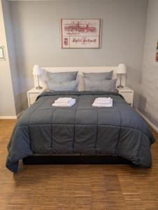 a bedroom with a large bed with two towels on it at Lendelhaus & Historische Saftfabrik Werder in Werder +17 photos