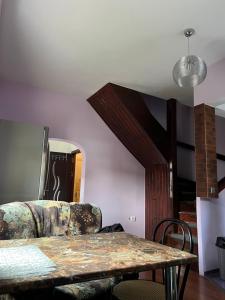 a living room with a table and a couch at House in the new center,Brasov in Braşov