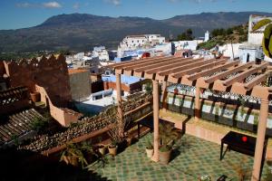 a view of a building with a roof with plants at Riad Cherifa in Chefchaouene