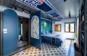a blue bedroom with a bed and a bathroom at Color House Sa Pa - Free BBQ in Sapa +21 photos