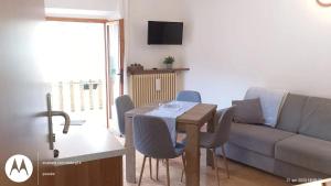 a living room with a table and a couch at Cozy apartment in Prabione, 30 m², charming balcony in Campione del Garda