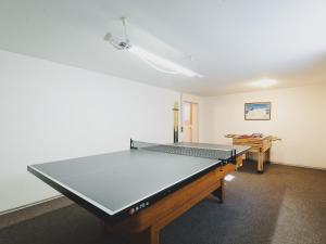 a ping pong table in the middle of a room at Chalet Nathalie by we rent, SUMMERCARD INCLUDED in Zell am See