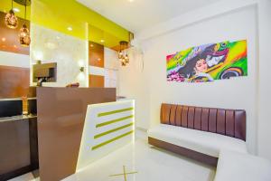 a living room with a couch and a painting on the wall at Hotel O Royal Palace in Kolkata