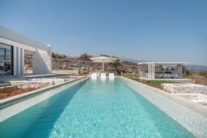 a swimming pool in the middle of a house at Nature & Beauty Villa in Xirostérnion