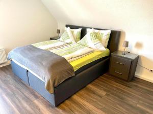 a bed in a room with a nightstand and a bed sidx sidx at Ferienwohnung Seehas am Bodensee in Friedrichshafen